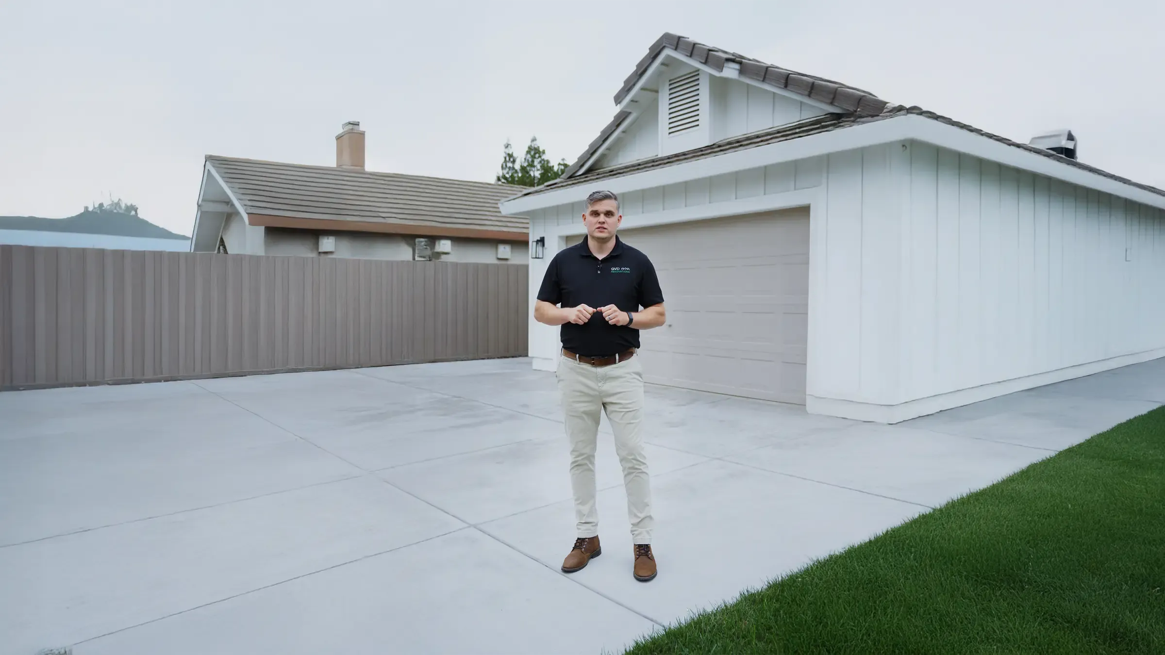 A man presenting a newly built house and garage